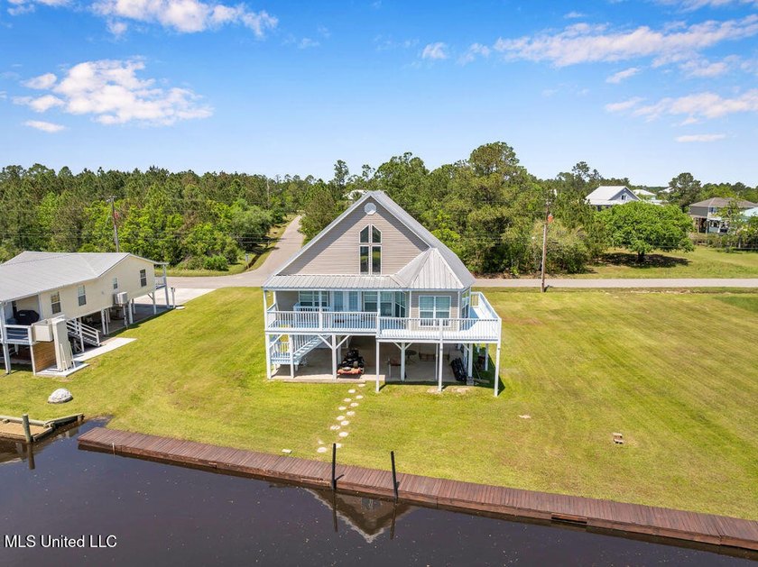 Located on a spacious waterfront lot in Bay St. Louis, this - photo 2