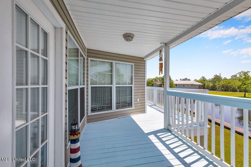 Located on a spacious waterfront lot in Bay St. Louis, this - photo 4