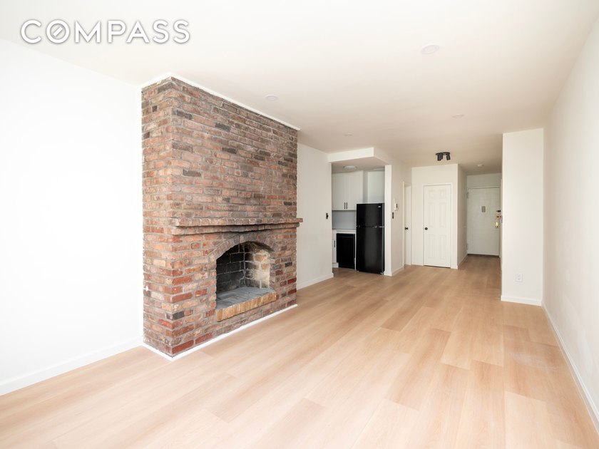 A pre-war brick fireplace, south-facing courtyard light, and a - photo 2