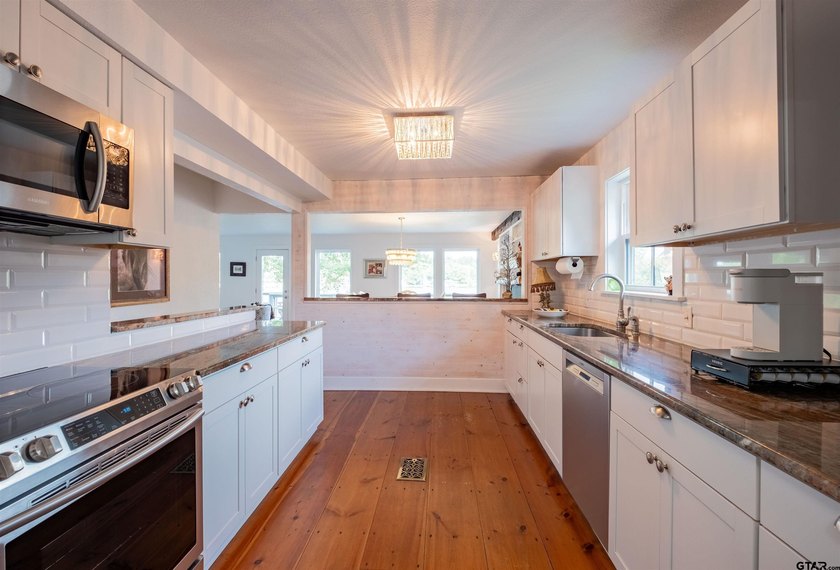 Main lake waterfront with private dock, updated interior, and - photo 12
