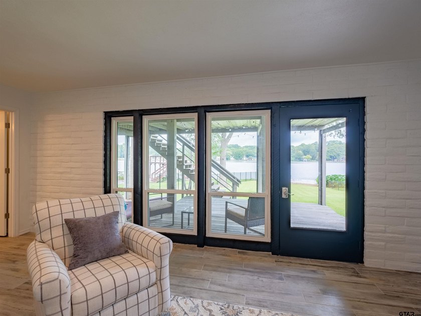 Main lake waterfront with private dock, updated interior, and - photo 23
