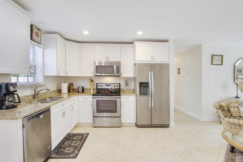 Welcome to this charming 4-bedroom, 2-bathroom home that - photo 2