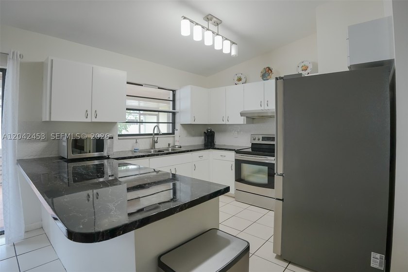 This charming 1988-built residence offers three bedrooms and two - photo 6