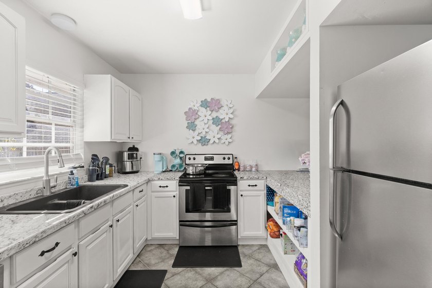 This renovated 2-bedroom, 2-bath condo has a newer roof (2022) - photo 7