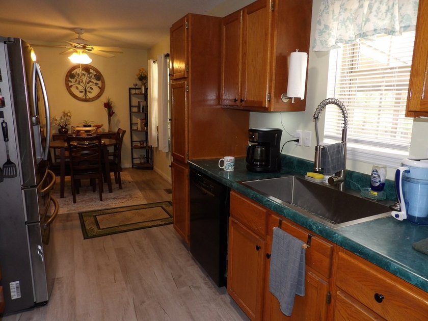 Well-maintained property featuring a 14' RV carport with hookups - photo 8