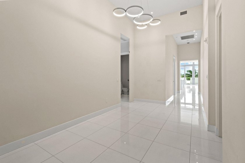 Step through the lobby level entry into ceilings that hold at - photo 2