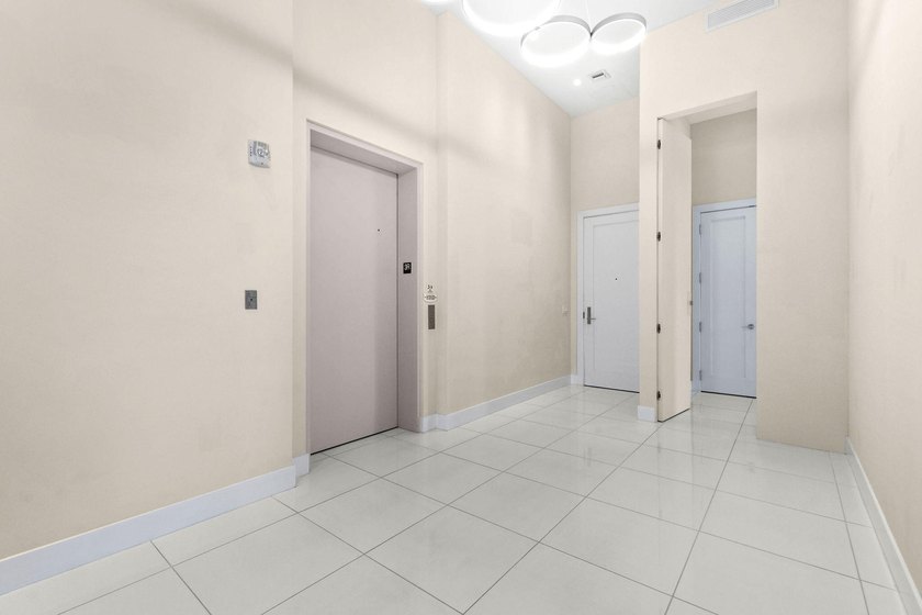 Step through the lobby level entry into ceilings that hold at - photo 3