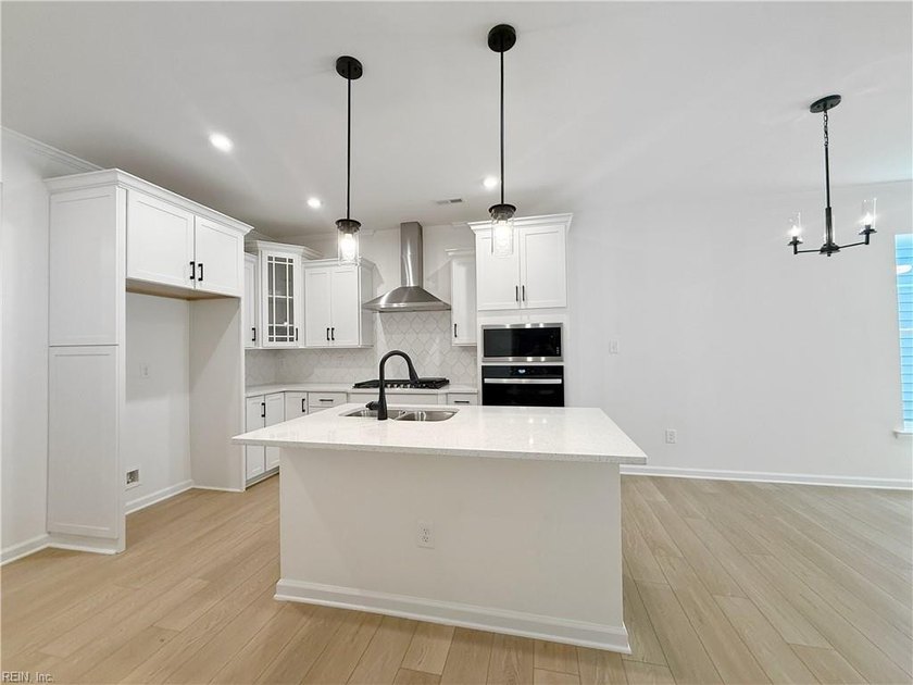 This home pairs soft sage-green and elegant frost gray cabinetry - photo 3