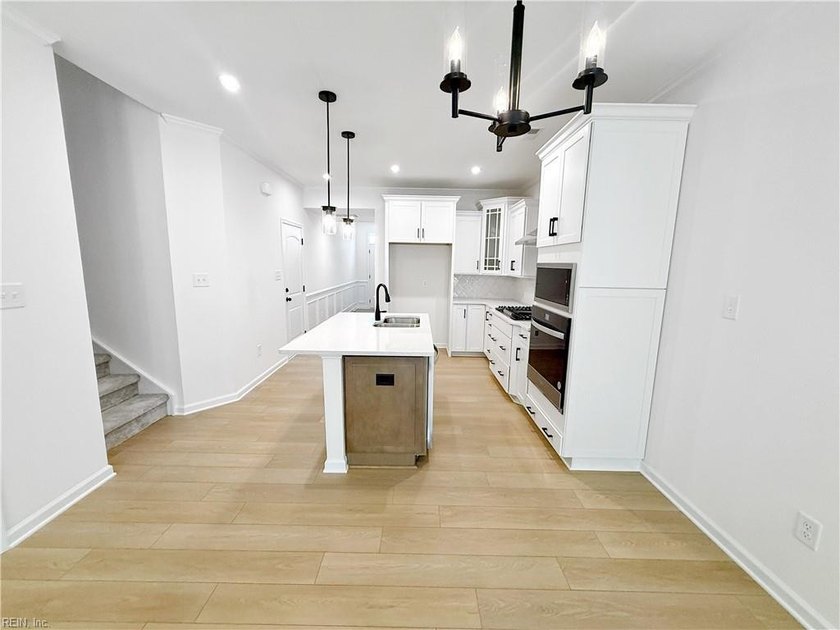 This home pairs soft sage-green and elegant frost gray cabinetry - photo 4