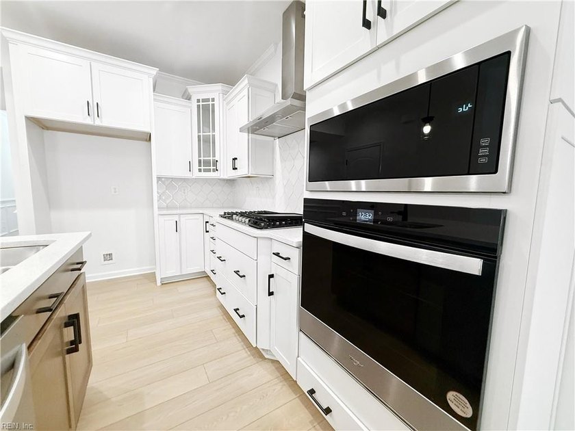 This home pairs soft sage-green and elegant frost gray cabinetry - photo 6