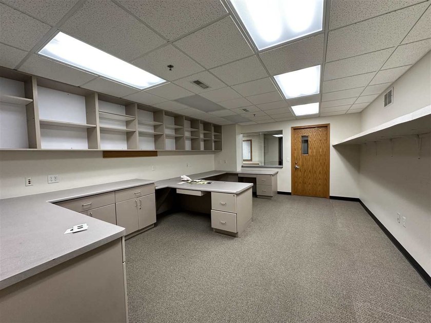 This large office offers 14 private offices, enclosed reception - photo 11