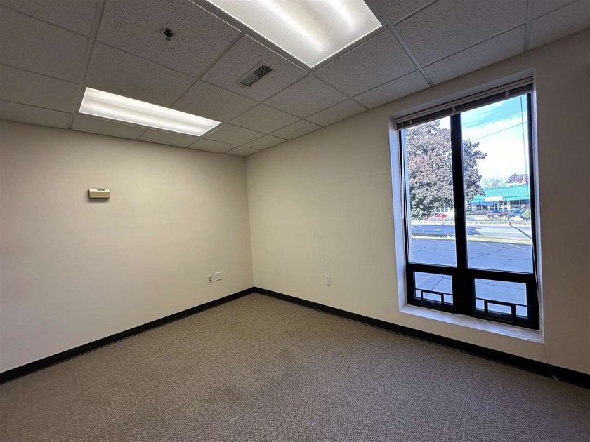 This large office offers 14 private offices, enclosed reception - photo 16