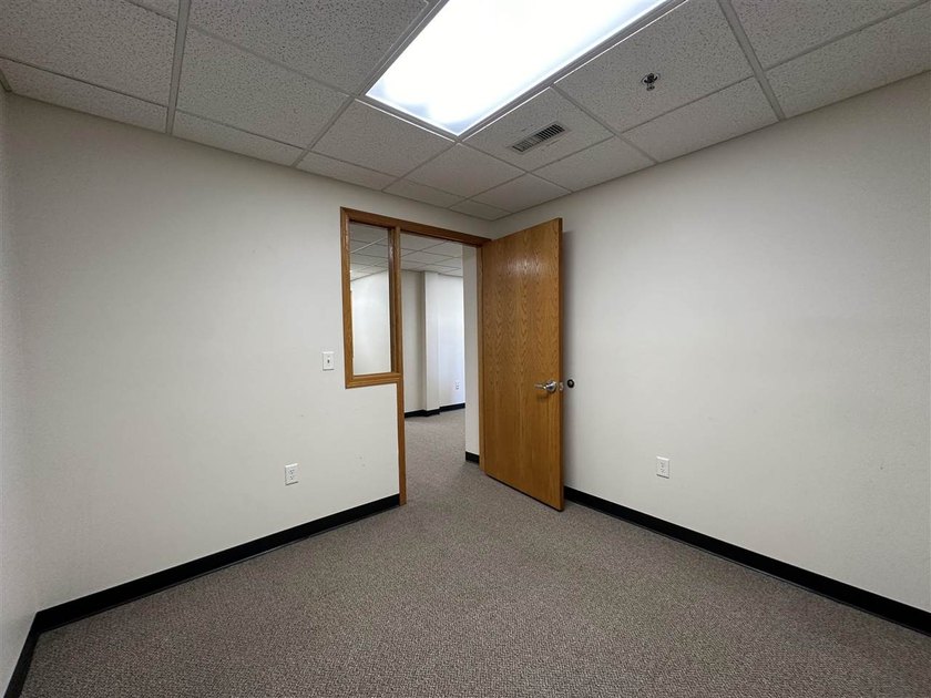This large office offers 14 private offices, enclosed reception - photo 29