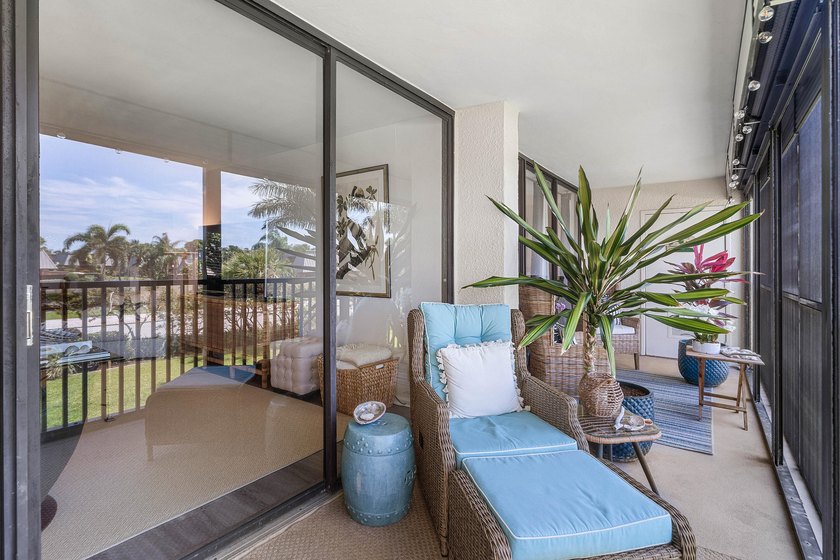 Positioned mere steps from the shoreline, this three-bedroom - photo 2