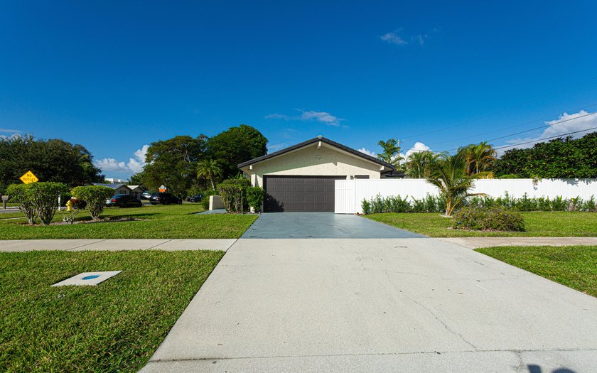 Tucked away on an oversized corner lot in the sought-after - photo 2