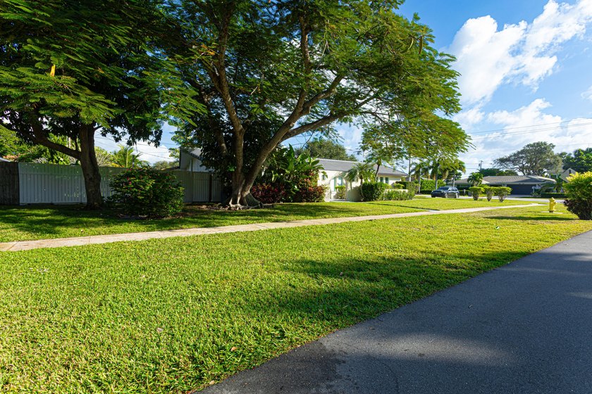 Tucked away on an oversized corner lot in the sought-after - photo 3
