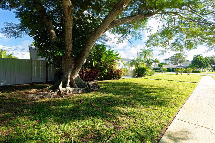 Tucked away on an oversized corner lot in the sought-after - photo 4