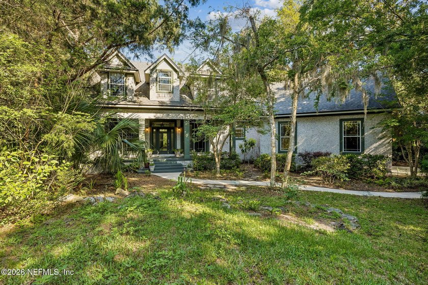 Nestled beneath a canopy of majestic live oaks and surrounded by - photo 3