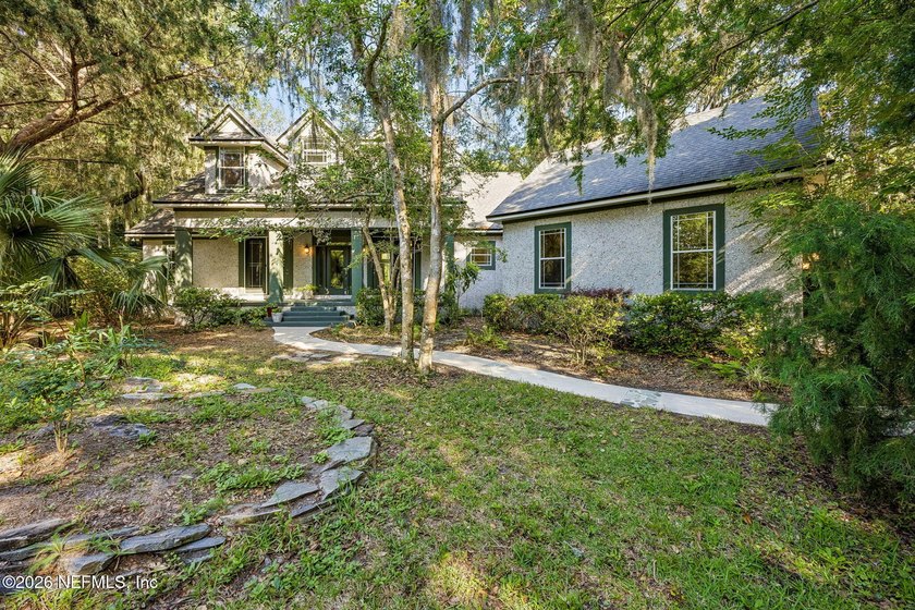 Nestled beneath a canopy of majestic live oaks and surrounded by - photo 5