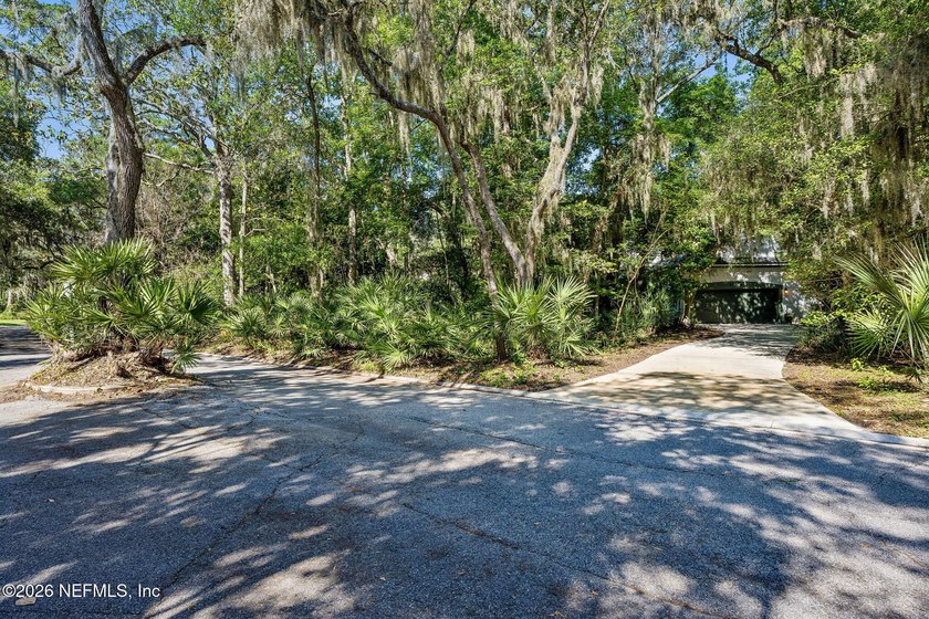 Nestled beneath a canopy of majestic live oaks and surrounded by - photo 6