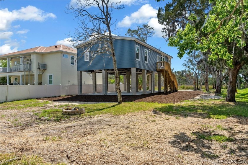 This brand-new stilt home sits on a deep-water canal in the - photo 39