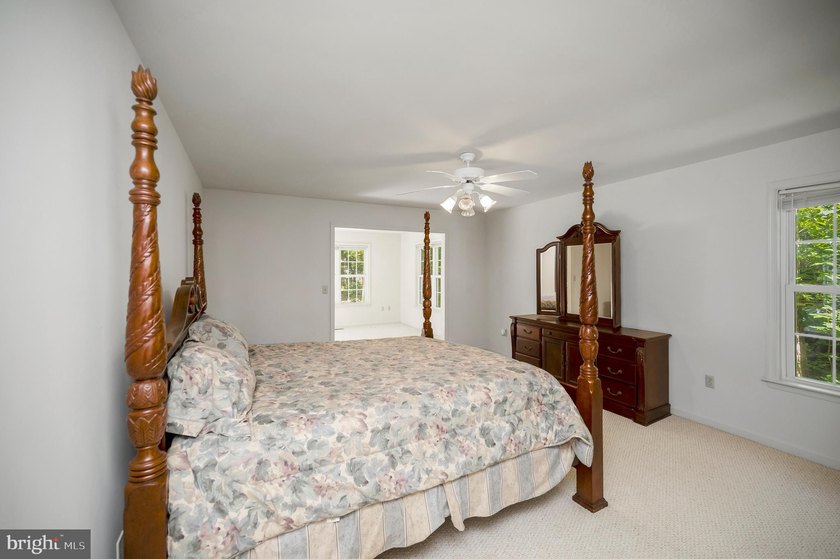 Nestled among mature green trees in the gated Lake of the Woods - photo 18