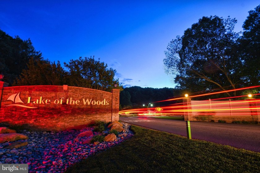 Nestled among mature green trees in the gated Lake of the Woods - photo 37