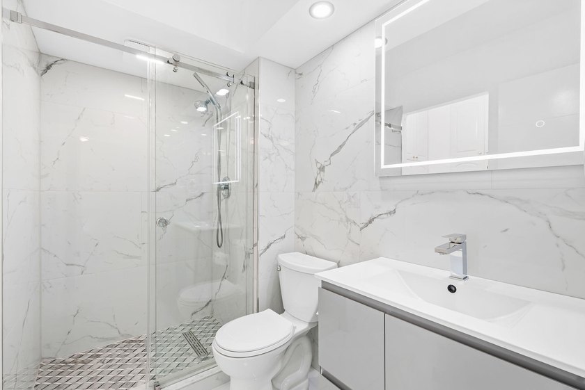 Stunning top-floor corner unit offering breathtaking wraparound - photo 9