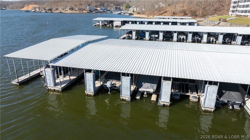 Huge screened deck, 12x32 boat slip with 8,000 lb lift, and rare - photo 34
