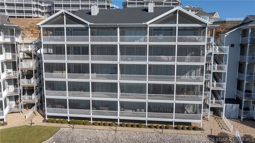 Huge screened deck, 12x32 boat slip with 8,000 lb lift, and rare - photo 36