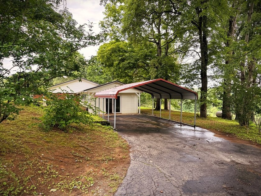 Tucked away on 5 fully fenced acres, this unique 3-bed, 2-bath - photo 2