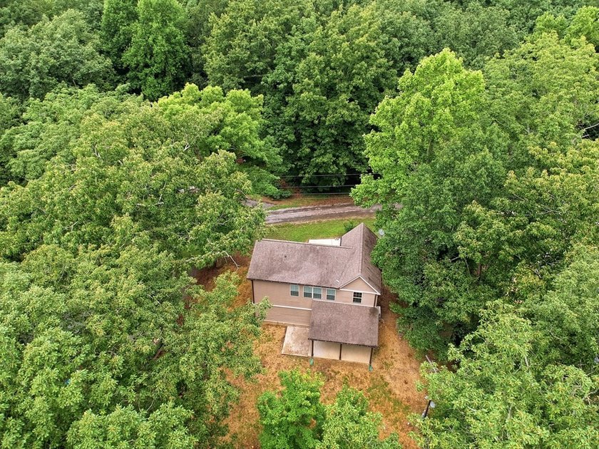 Tucked into a private, wooded setting just minutes from Center - photo 10