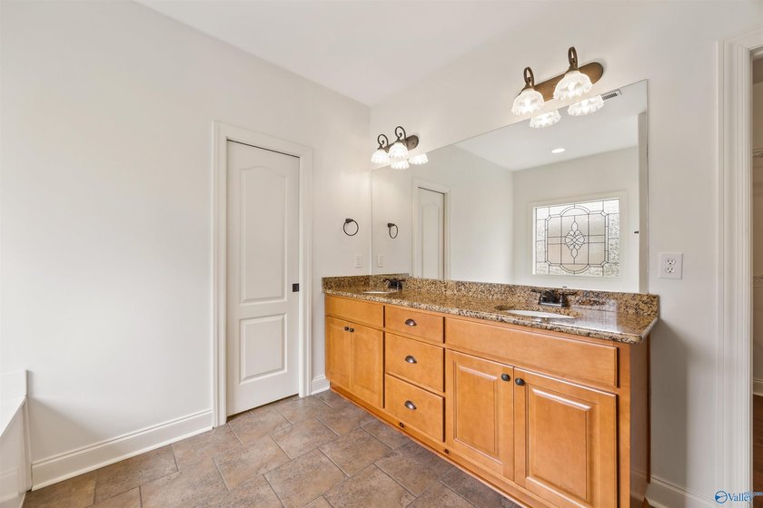 Lake-view ranch featuring 4 bedrooms, 4 full baths, a spacious - photo 19