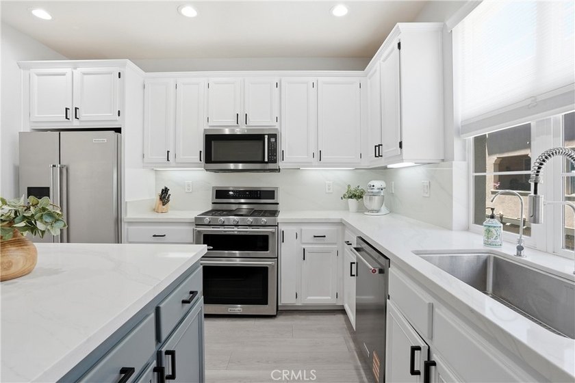Welcome to this highly upgraded three-bedroom residence in the - photo 8