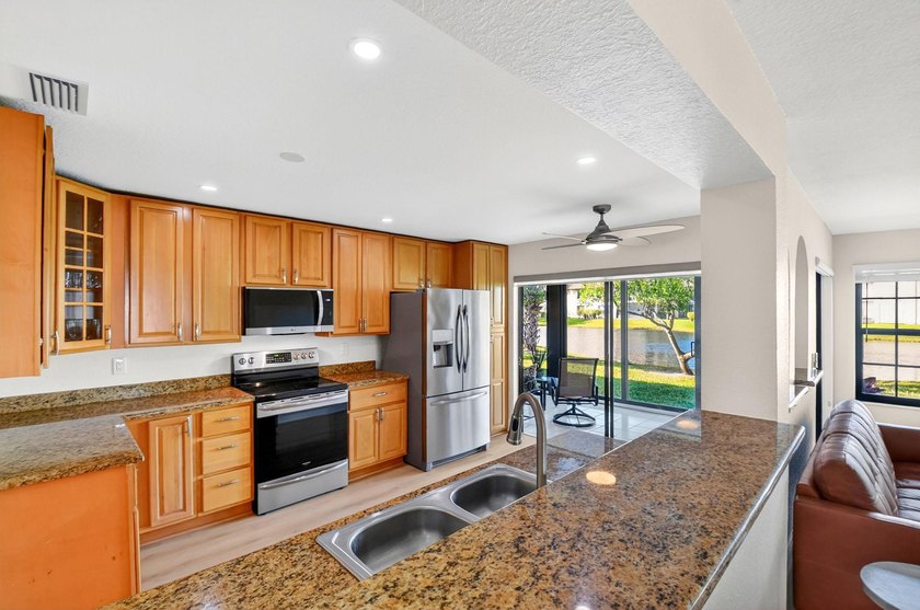 STUNNING LAKESIDE RENOVATION! 1st-floor condo offers expansive - photo 3