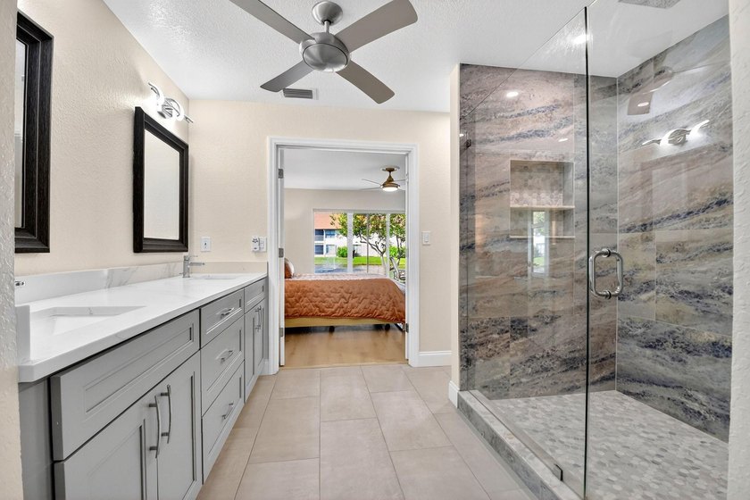 STUNNING LAKESIDE RENOVATION! 1st-floor condo offers expansive - photo 9
