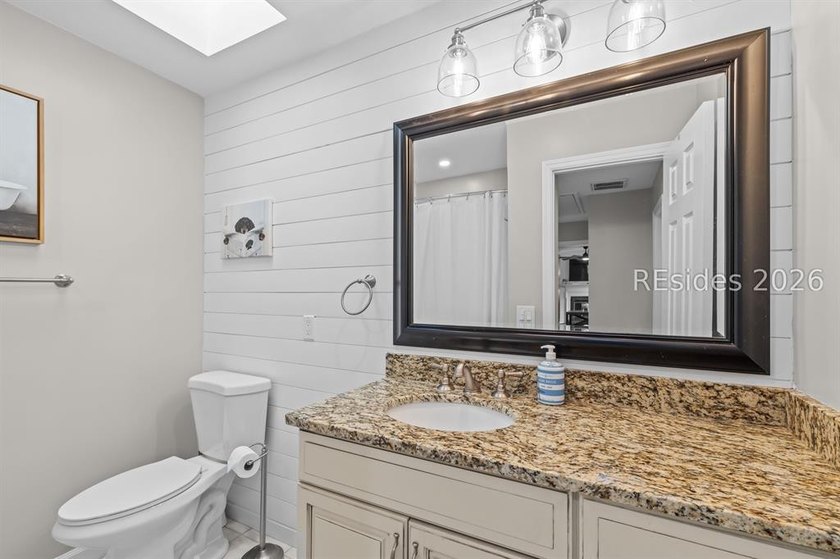 This beautifully updated residence offers laminate wood flooring - photo 32