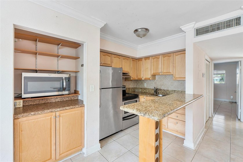 Discover a chic 2-bedroom, 1-bath corner unit condo with - photo 2