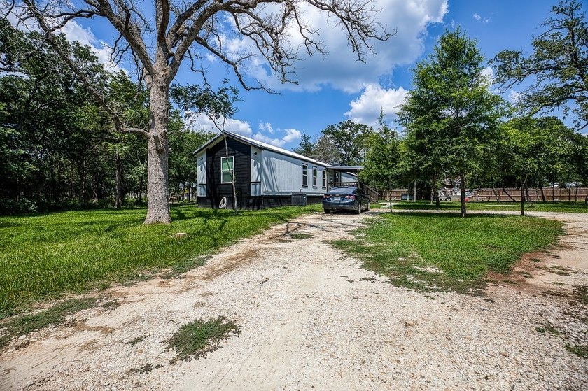 ***PRICE REDUCTION*** Nestled on a serene one-acre lot, this - photo 3