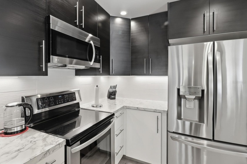 Welcome to this beautifully RENOVATED second-floor condo - photo 5