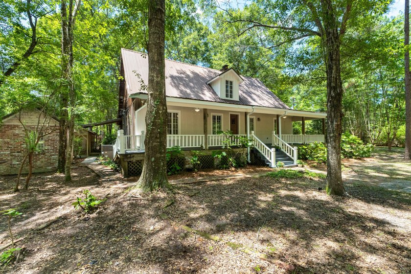 Hidden beneath towering hardwoods on a private wooded setting - photo 2