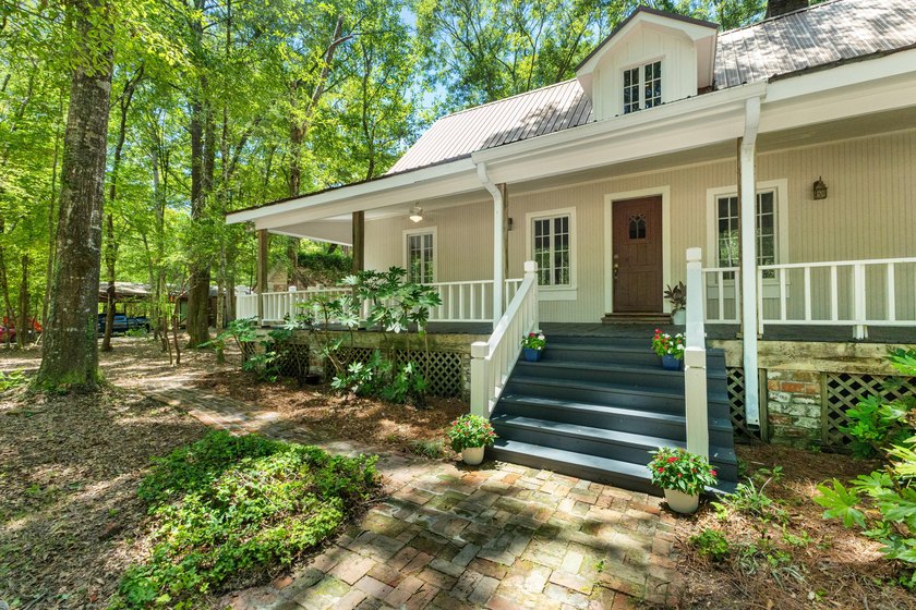 Hidden beneath towering hardwoods on a private wooded setting - photo 4