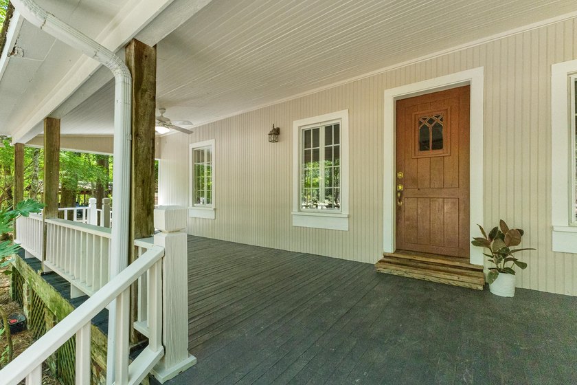 Hidden beneath towering hardwoods on a private wooded setting - photo 5