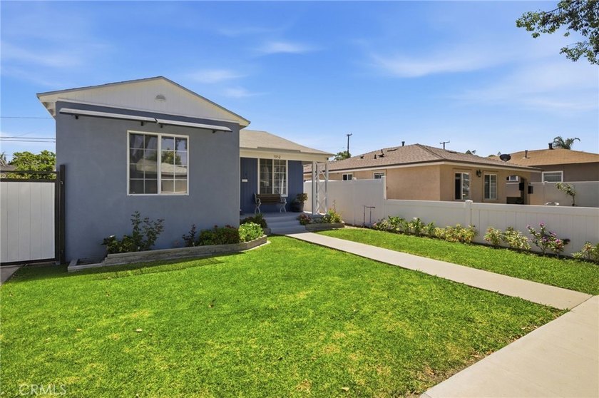Nestled on a quiet tree lined street in North Long Beach, this - photo 3