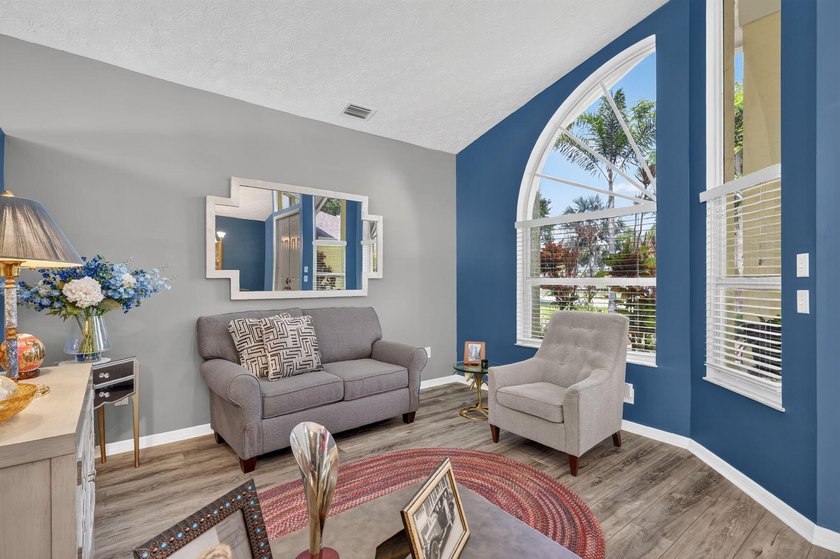 Palm trees sway over your private, screened pool at this move-in - photo 8