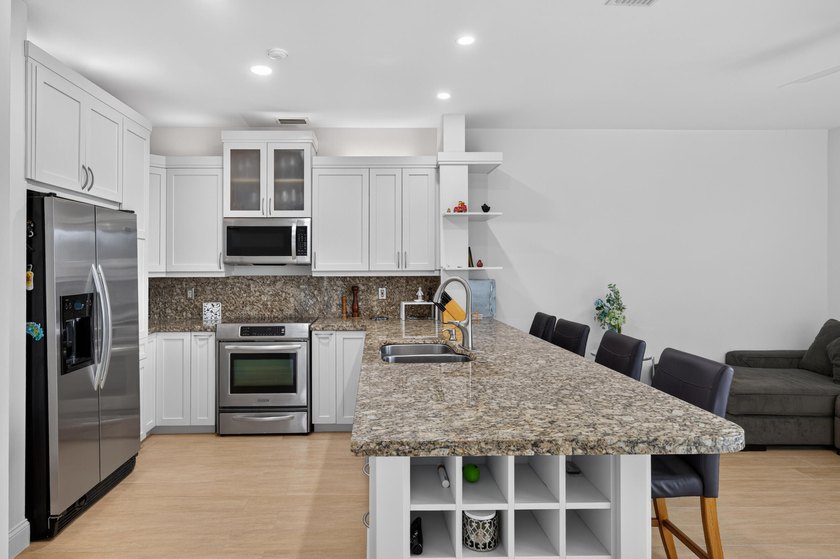 Welcome to this stunning waterfront residence nestled in The - photo 10