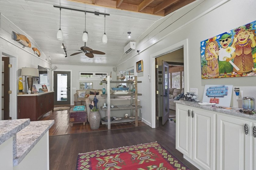 This one-of-a-kind coastal retreat blends island-style charm - photo 9