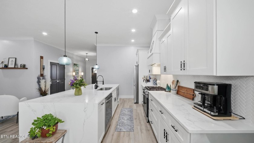 Welcome home to this beautifully designed five bedroom, two and - photo 10
