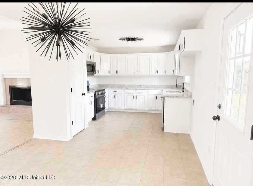 This beautifully updated 4-bedroom, 2-bath home is located in a - photo 9