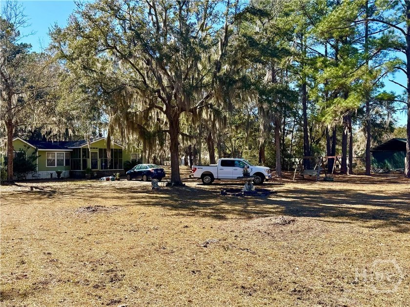 Sitting on a full acre with beautiful mature oaks, this home - photo 3